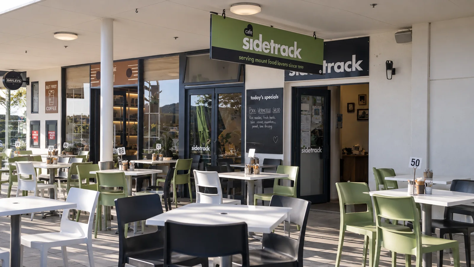 Sidetrack cafe storefront and outdoor dining area on Marine Parade